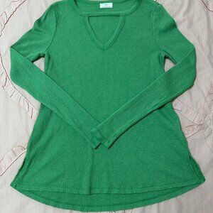 Green long sleeve top with V-neckline.
